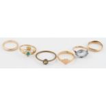 A collection of six rings, to include an oval cut blue paste ring, a hallmarked 9ct yellow gold