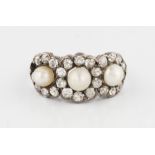 A pearl and diamond ring, set with three pearls, each surrounded by a border of old cut diamonds,