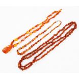 Three strings of amber beads, one of polished angular beads with treated amber dropper, one of