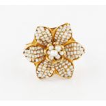 An Indian style seed pearl flower design ring, markings rubbed, ring size F½.