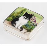 A silver and enamel pill box, of square form with enamel black and white cat design to lid,