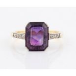 An amethyst and diamond ring, set centrally with an emerald cut amethyst, measuring approx.