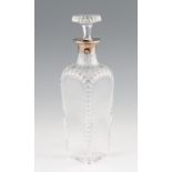 An early 20th Century silver mounted glass decanter, with cut glass decoration with matching