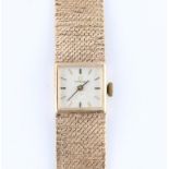 A 9ct yellow gold cased ladies Omega wrist watch, the silver tone dial having hourly baton