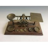 An S. Mordan & Co. brass graduated postal scales on oa base with set of weights from 1/2-16 oz.