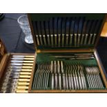 Two large cutlery sets in wooden boxes.