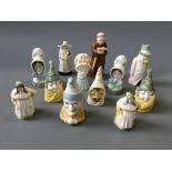 Twelve Royal Worcester character snuffers including Punch, Old Woman, Mr Caudle, Budge, etc.