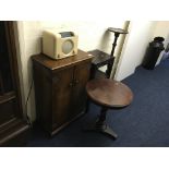 An oriental plant stand, walnut two door cabinet, plant stand and a small table.