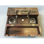 A rosewood portable inkwell set.