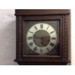 An oak cased Westminster chiming grandmother clock.