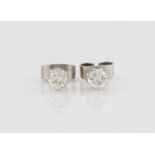 A pair of diamond stud earrings, each set with a round brilliant cut diamond, each approx. 0.20ct,