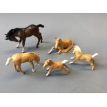 Five Beswick horses, four palomino and one brown.
