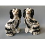 A pair of Staffordshire black and white spaniels.