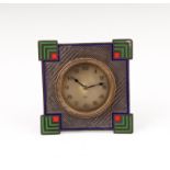 An Art Deco silver and enamel surround desk clock, of geometric design highlighted in green, blue