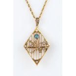An early 20th Century aquamarine and seed pearl pendant, of diamond open metalwork design, set
