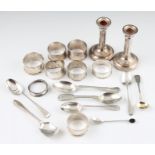 A collection of hallmarked silverware, to include a pair of weighted candlesticks, eight various