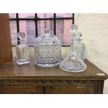 Three glass decanters with toppers and one lidded bowl.