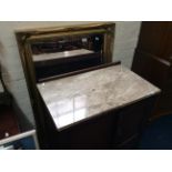 An oak two door, marble top cabinet with a gilt framed mirror.