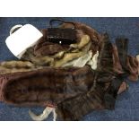 Two handbags and a selection of fur scarves and wraps.