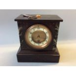 A black slate mantel clock.