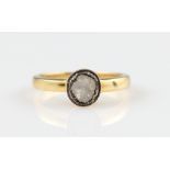 A diamond ring, set with a foil backed flat cut diamond, in unmarked yellow metal, ring size L½.