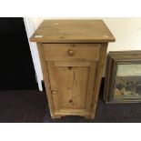 A pine bedside cabinet.