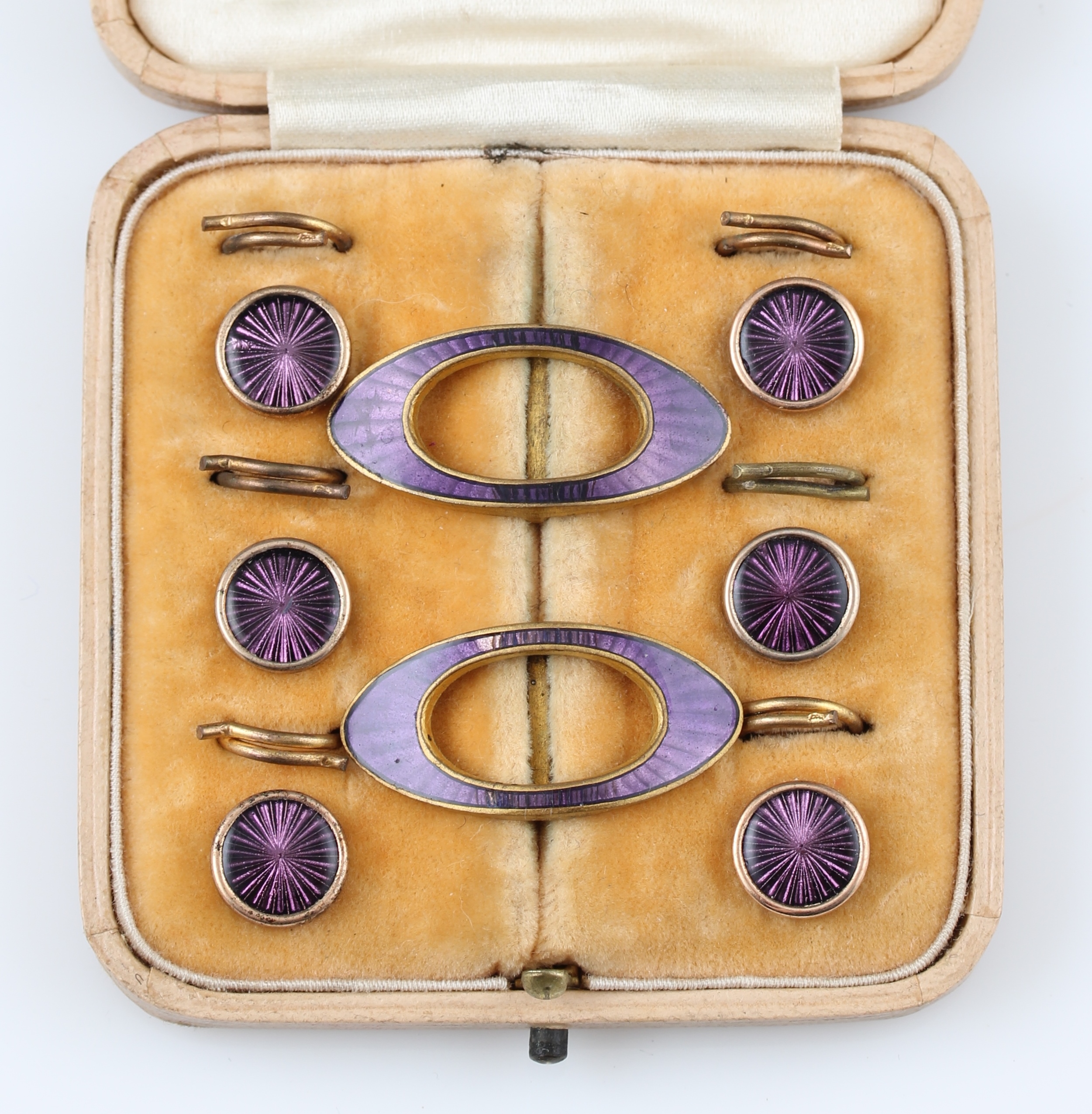 A set of two enamel buckles and six enamel buttons, housed in a fitted case.