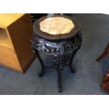 A Chinese marble top jardiniere with fruit and leaf design.