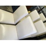 A set of eight white leather upholstered dining chairs