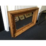 A pine framed mirror, 86cm x 126cm.