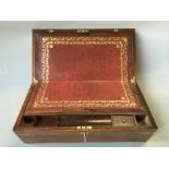 A rosewood writing slope with red leather interior and exterior brass details.