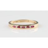A 14ct yellow gold ruby and diamond half eternity ring, channel set with alternating round cut