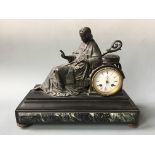 A mantel clock on marble base encased by bronze papal sculpture. Height 22cm.