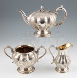 A silver plated Elkington & Co. three piece tea set, comprising of a tea pot, milk jug and sugar