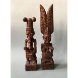 Two Gani Fakeye wooden sculptures, one kneeling, one standing. Heights 36.5cm and 45cm.