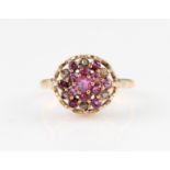 A 9ct yellow gold ruby and diamond tiered cluster ring, set with two tiers of round cut rubies,