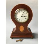 An Edward mahogany balloon shaped mantel clock with satinwood detail. Height 26cm.