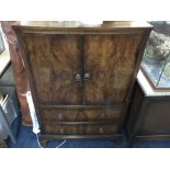 A walnut cabinet with two drawers to base and mirrored back.