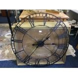 Four gilt picture frames and a large circular wall clock.