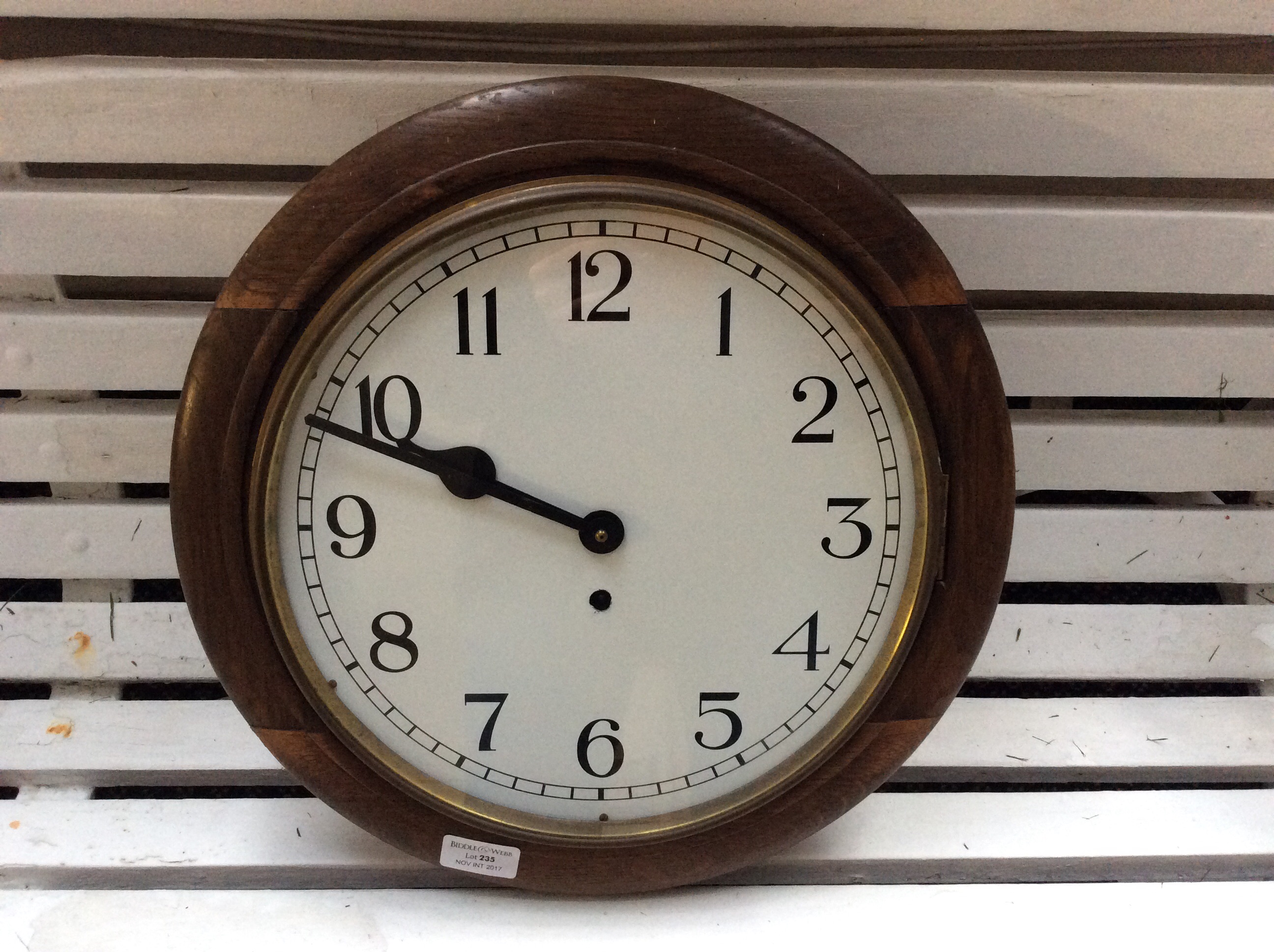 An oak cased circular wall clock.