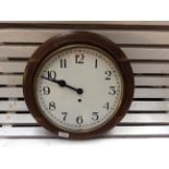 An oak cased circular wall clock.