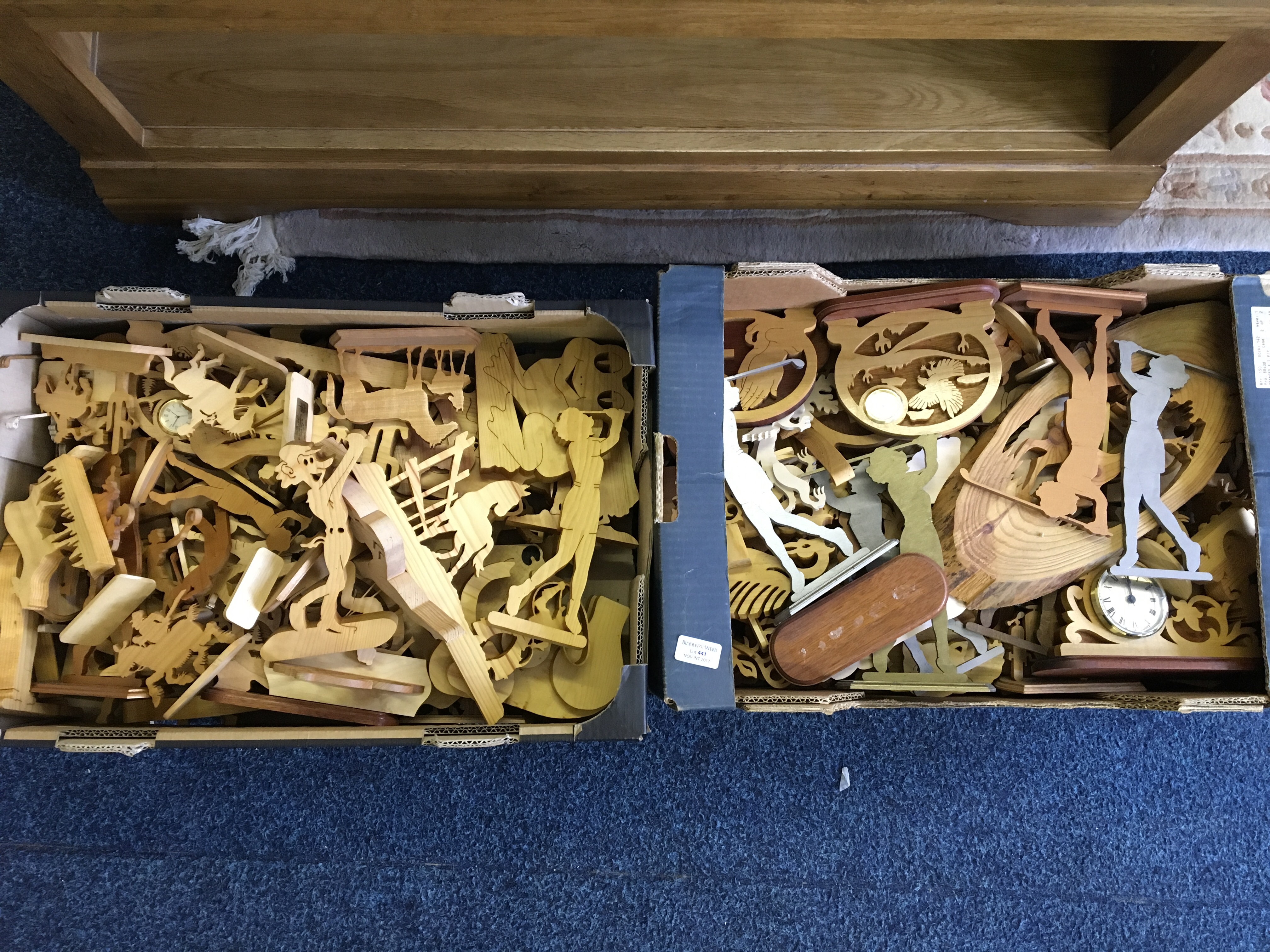 Two boxes of carved wood ornaments.