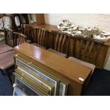 A teak dining room set including drop leaf table, six chairs and three drawer sideboard.