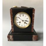 A French 19th Century black and red marble mantel clock. Height 55cm.