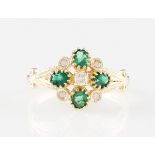 *A 9ct yellow gold emerald and diamond ring, set with four oval cut emeralds interspersed with round