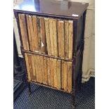 A mahogany two tier bookshelf with Encyclopaedia Britannica Eleventh edition.