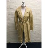 A Jean Muir tan collared leather coat with zig zag hole punch design to edges and belt, size 10.