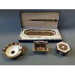 An Old Crown Derby lidded pot, tea strainer, bench and desk set.