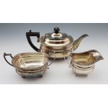 A silver three piece tea set, comprising of a tea pot, sugar bowl and milk jug, all of squat form