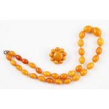 A knotted string of graduated butterscotch amber beads, comprising of approx. 31 oval amber beads,